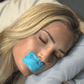 woman sleeping with blue mouth tape