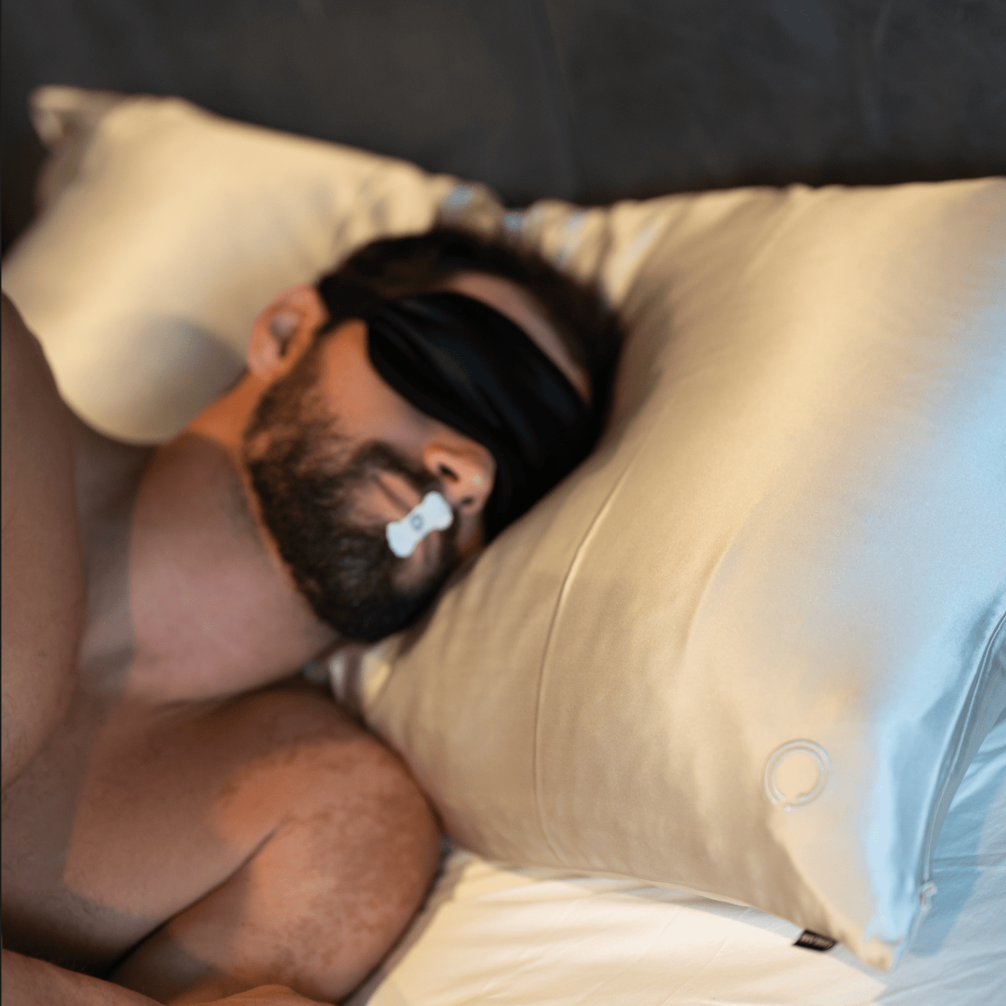 man sleeping with mouth strip and sleep mask
