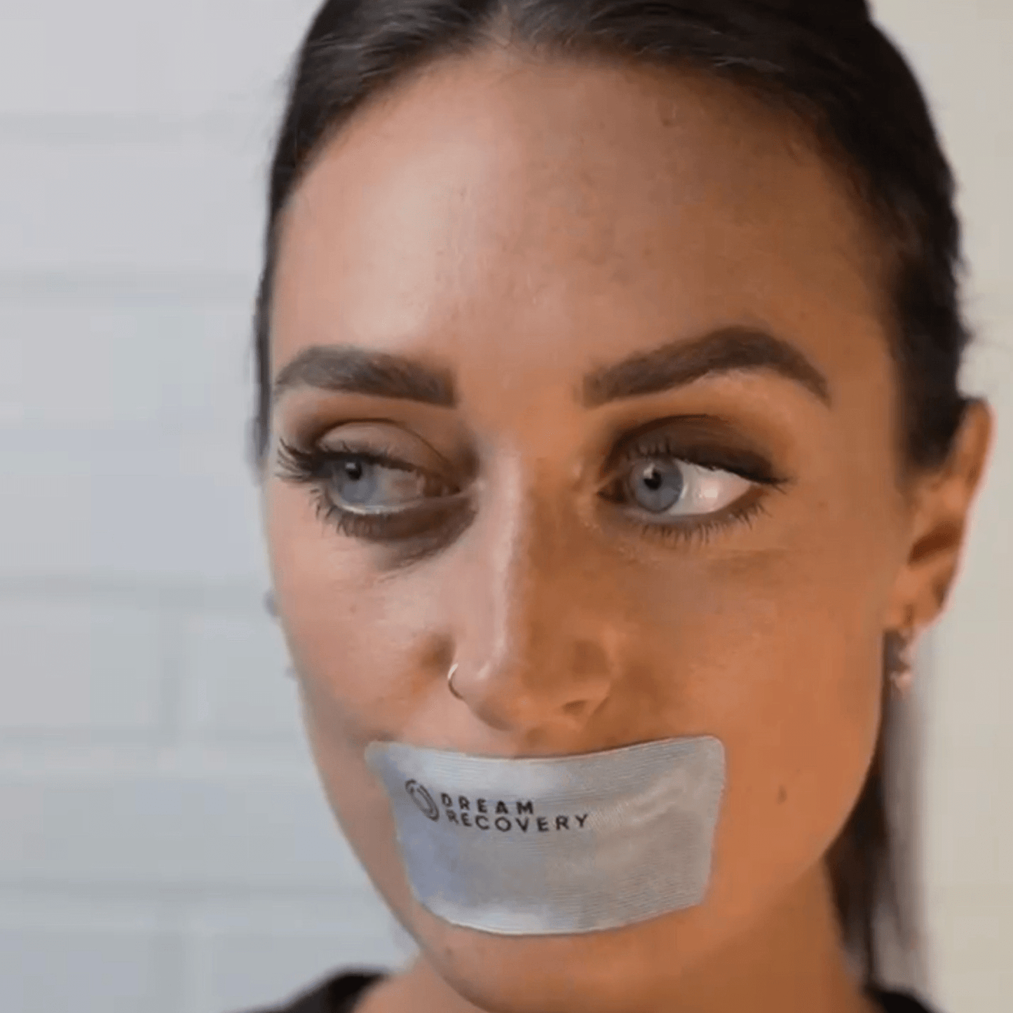 woman with gray mouth tape